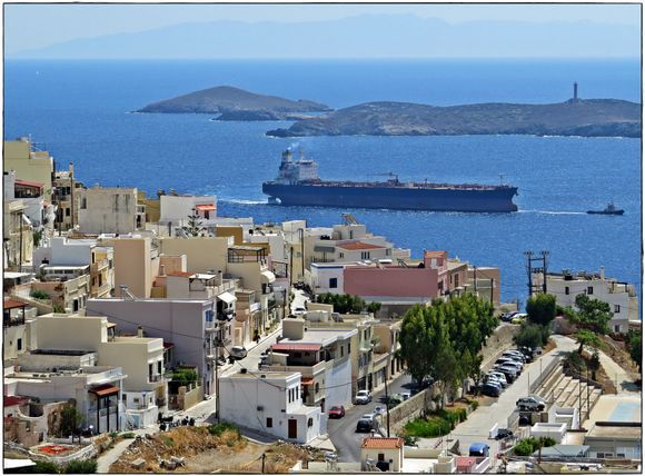 13-09-2022 Syros: Ermoupolis .......View on a piece of Ermoupolois with a boat being towed towards the harbour