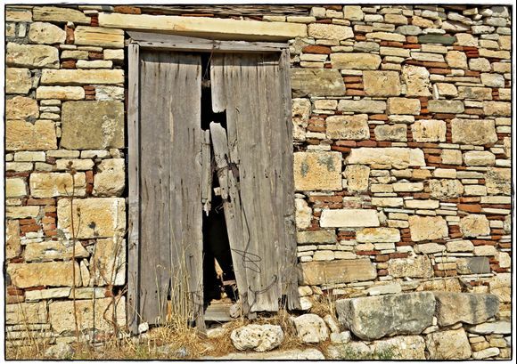 22-09-2020 Samos: Pythagorio .......Old wall with old door in the landscape near Pythagorio