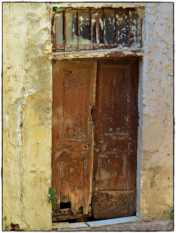 16-09-2021 Chania: A door with a small piece of green 