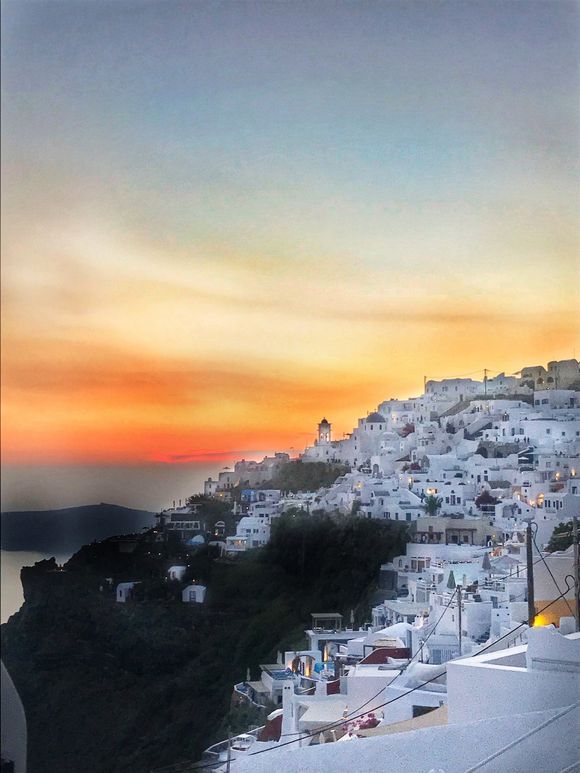 Fira sunsets over white washed buildings