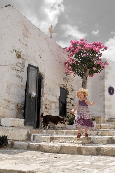 Paros - a girl with dog in the streets of Parikia