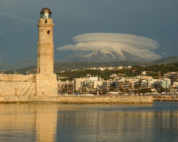 Rethymno's Egyptian lighthouse with cloud covered Psiloritis mountains in the background.