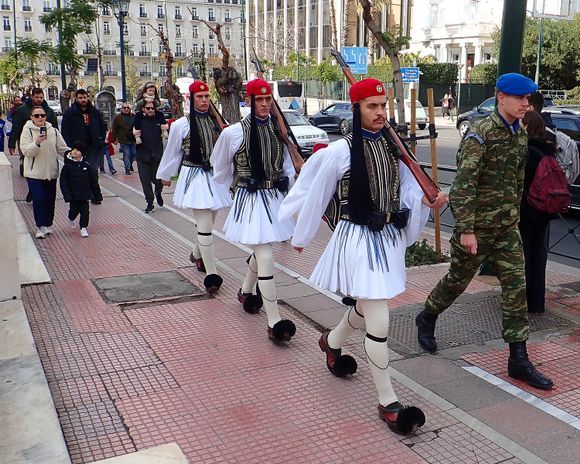Members of the Evzones (Parliment guards) march away from the Monument of the Unknown Soldier following their guard duty assignment.  The Evzones is a special unit of the Hellenic Army, also known as Tsoliades, who guard the Monument of the Unknown Soldier in front of the Hellenic Parliament and the Presidential Mansion.
