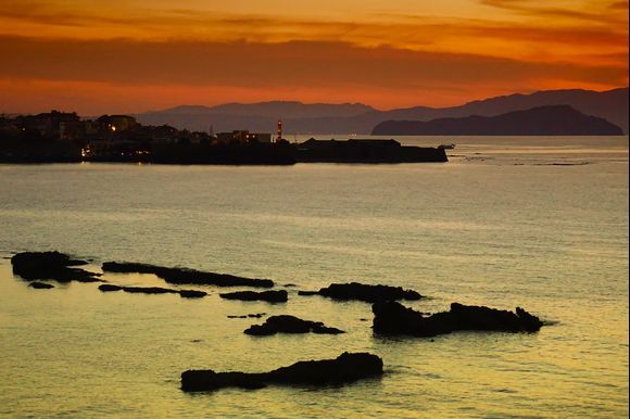 Silver sea with golden sky just after sunset. Seascape shot from above Chania's Honolulu Beach.