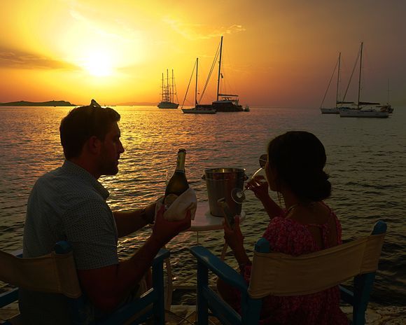 A couple enjoys a chilled refreshment along with a Mykonos sunset at Little Venice.  Here's to never seeing too many beautiful Greek sunsets! Yamas! ;-)
