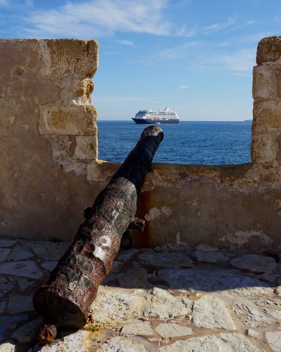 The cruise ship Azamara Pursuit sits anchored outside of Chania's Venetian harbor.  On the northern side of the Firka Fortress wall, there are six arched openings that included cannons for the protection of the entrance of the harbor.