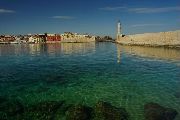 A scenic shot of Chania's old Venetian harbor. I like the pair of grey mullet fish in lower right attesting to the water clarity.