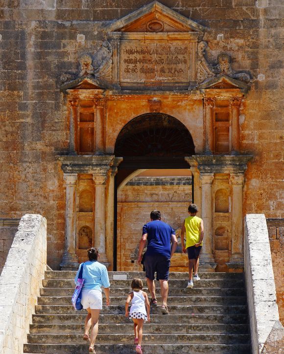 A family climbs the stairs to the monastery entrance.