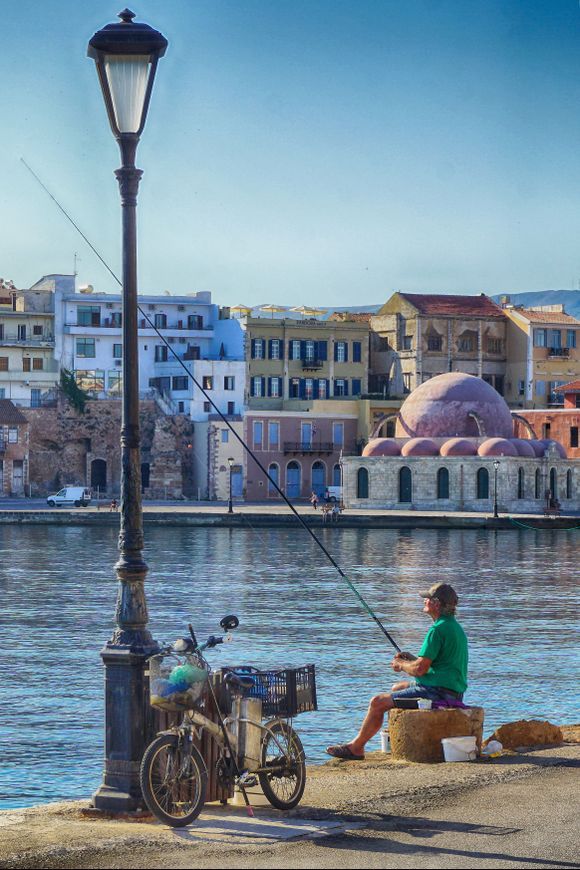 The Waiting Game - A local fisherman tries his luck in the Chania harbor.