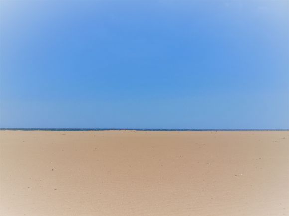 Matters of perspective: the thin blue line that lies between the sky and the sand is the immense Aegean sea... 