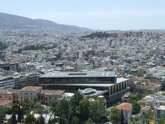 The modern city of Athens seen from the Acropolis hill with the new Acropolis museum in the foreground