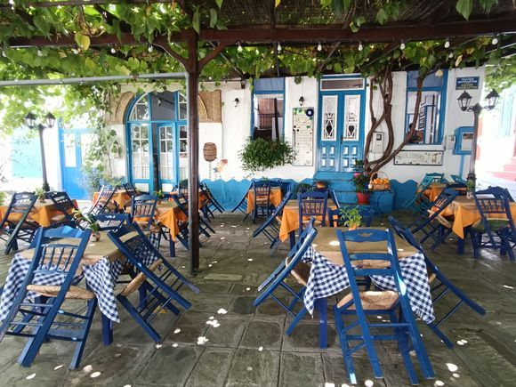 Blue chairs in Vourliotes, small village near Tsamadou beach