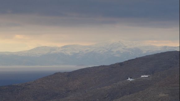 Amorgos in winter time : Agios Ioannis chapel communing with snow capped Naxos