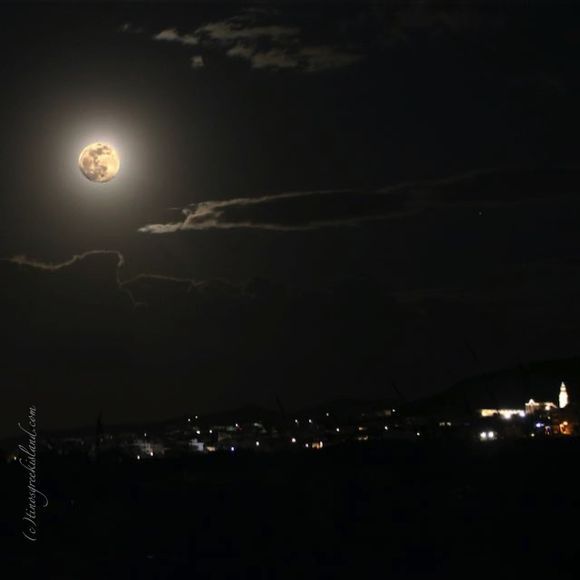 early morning full  moon above Tinos Chora
