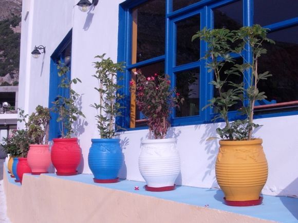 colourful pots outside a Kamari taverna