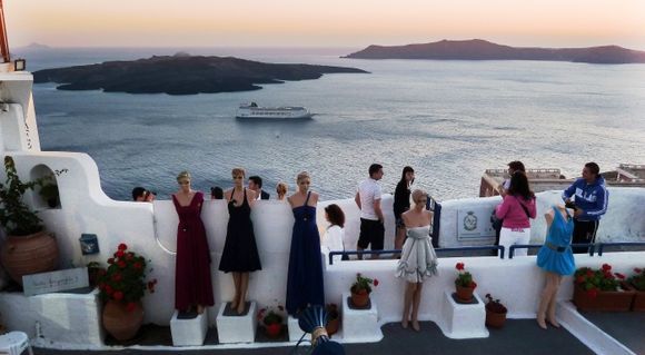 a mix of people and dolls during the sunsetin Fyra, Santorini