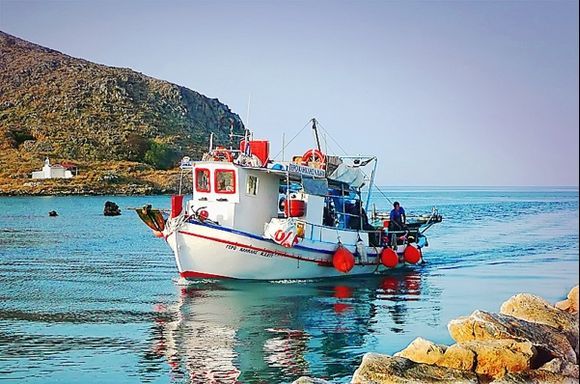 A fishing boat entering the harbour of Georgioupolis on Crete