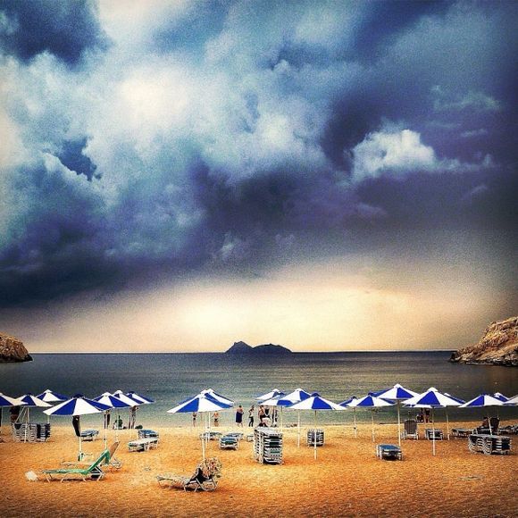 Out of the blue a thunderstorm appeared over the lybian sea in matala, crete. Everyone jumped out of his beachchair and went to the shore to see what would happen:and what a downpour it was!?