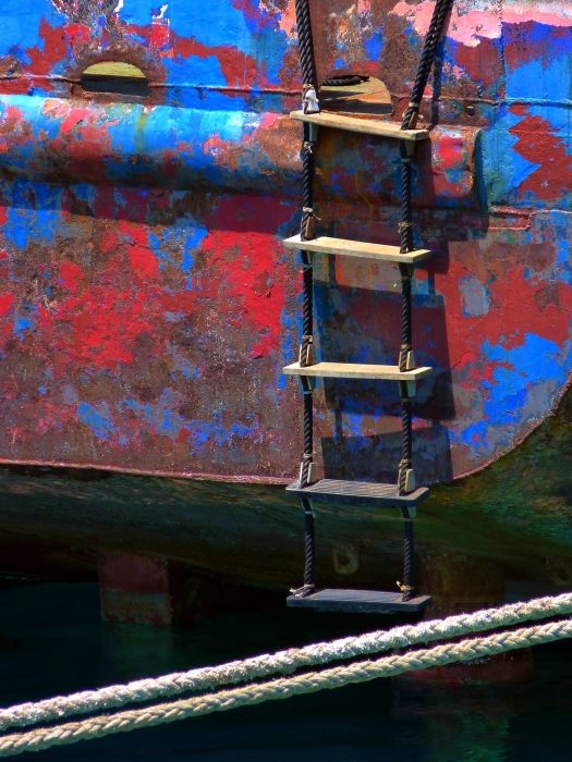 Rusted boat and ladder at ship building yard