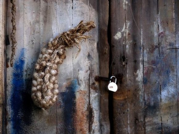 Wooden door, lock and garlic