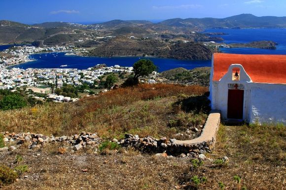 Panorama with Skala view and small church on top of the hill