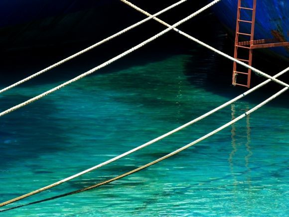 Blue sea, red ladder and ropes