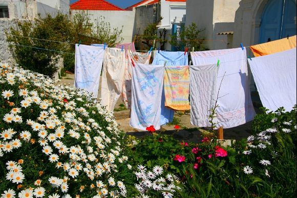 A garden with flowers and clothes drying in the sun, Koskinou