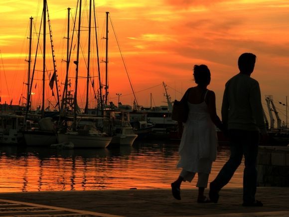 Sunset at Naxos harbour with couple