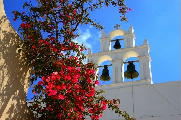 Pyrgos, bell tower and bougainvillae