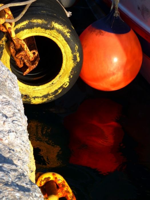 Orange buoy and yellow tyre