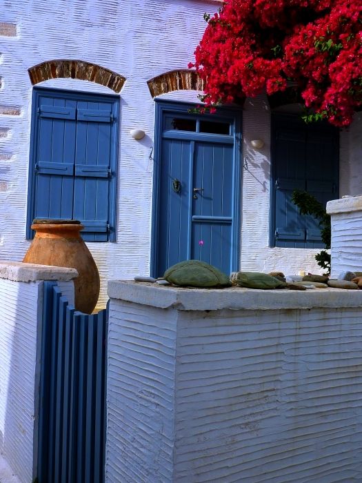 Blue facade with bougainvillea and clay pot