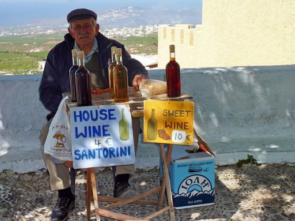 Man selling local wines in the village of Pyrgos