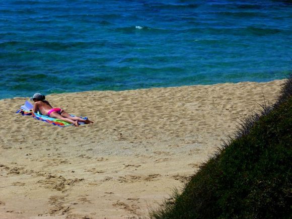 Sunbather on Naxos sandy beach
