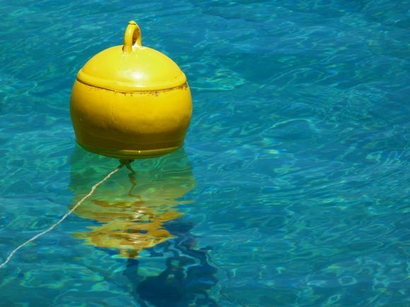 Yellow buoy and delightful blue sea