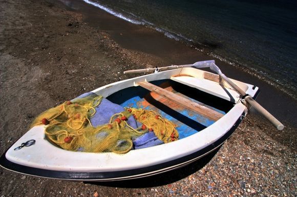Wooden boat and nets on the beach