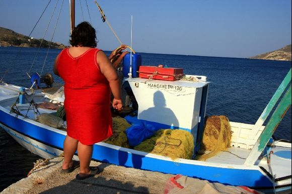 Woman in red and fishing boat, Alinda