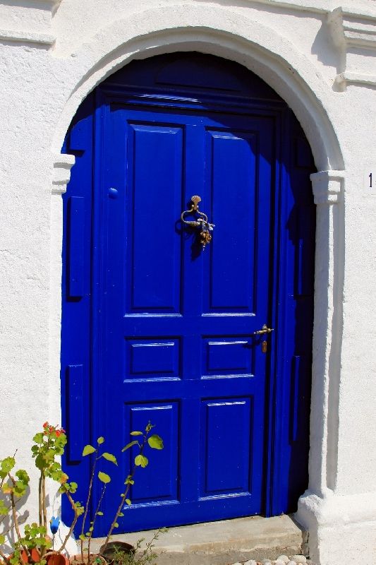 Traditional house with blue door in Koskinou