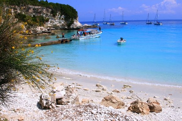 Voutomi beach on Antipaxos island with sails and excursion boat