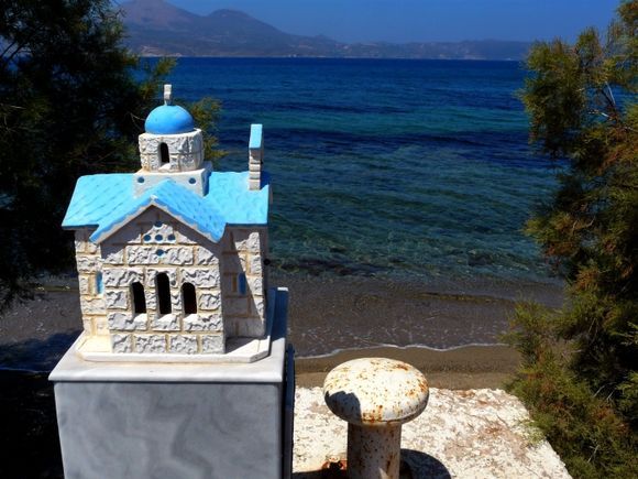 Miniature church on the edge of Adamas beach