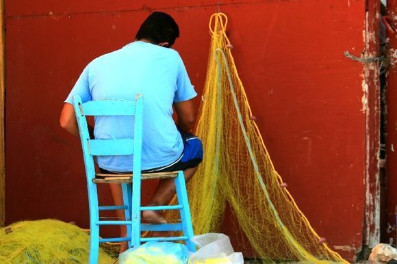 Rear view of man and nets, Kaminia harbour