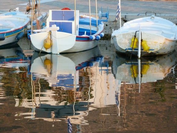 Boats in harbour reflected in the water