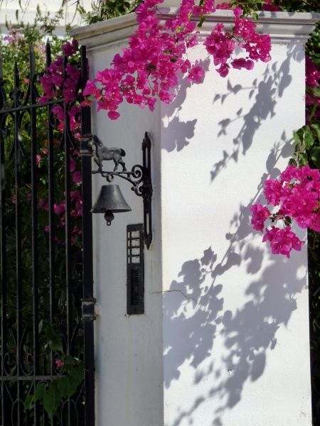 Entrance with bell and bougainvillae