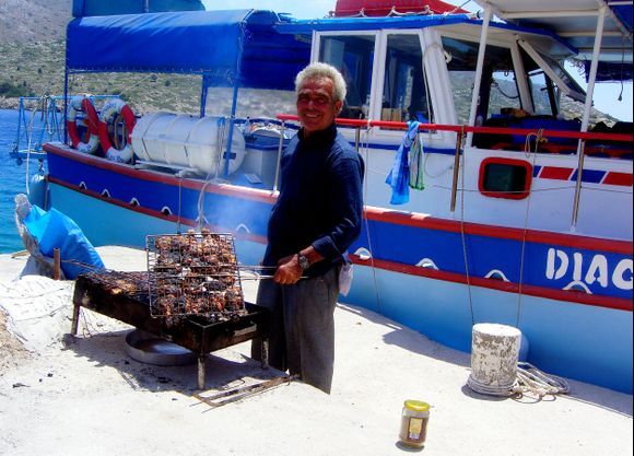 Man cooking barbecue and excursion boat