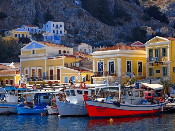 Colorful neoclassical houses and fishing boats, Gialos, Simi island, Dodecanese