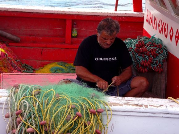 Fisherman mending nets and ropes