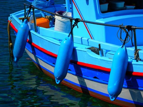 Blue fishing boat and buoys, Kini