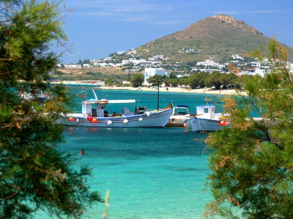 Naxos town white beach with blue sea and fishing boats