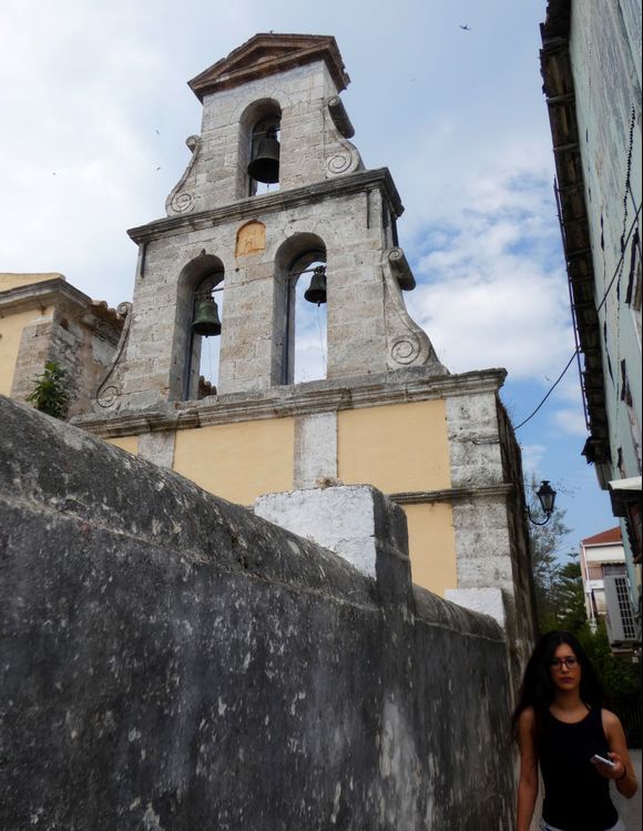 Girl walking past a church in Lefkas town