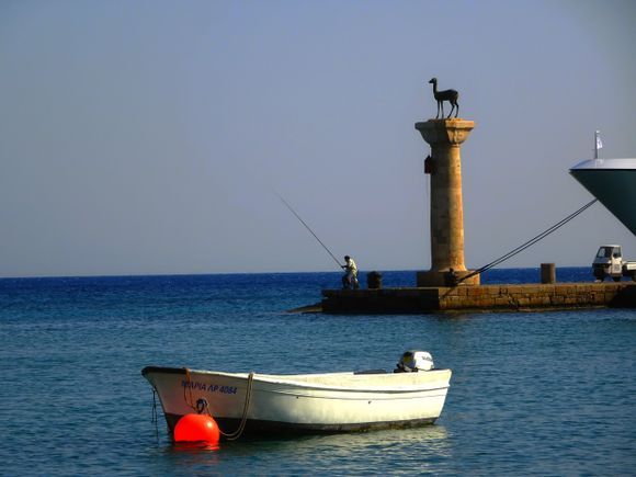 Fisherman and boat at Mandraki harbour, Rodos town