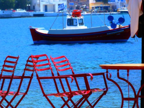 Waterfront with red chairs, Katapola